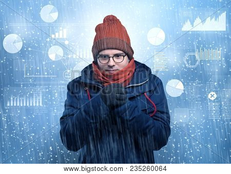 Young businessman shivering with graphs, reports and chart concept