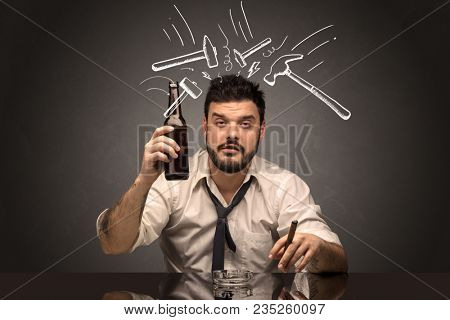 Young drunk disappointed man with hangover concept