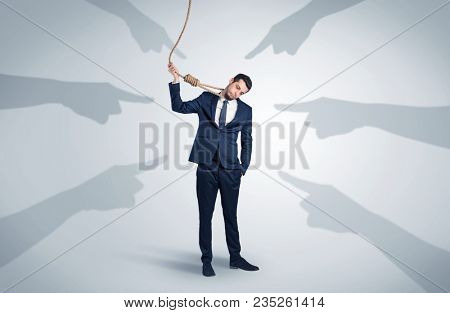 Young businessman trying to suicide with pointing hands concept