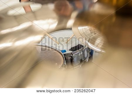 Drummer Playing On Drum Set Top View. Live Music Concert, Band During Performance. View And Look Thr