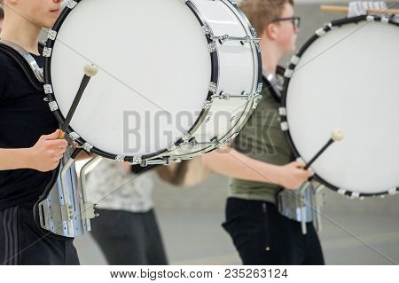 Musicians March, Play And Make Music With Large Bass Drums