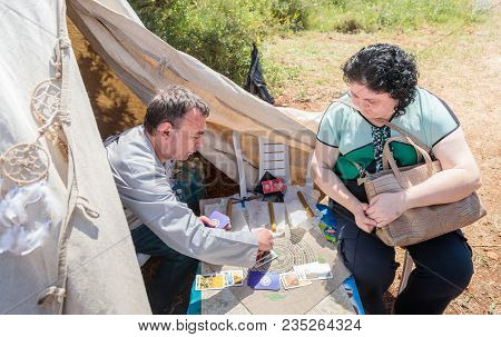 Goren, Israel, April 06, 2018 : Fortune Teller On Tarot Cards - Participant Of Knight Festival Answe