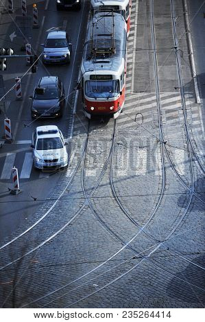 Prague, Czech Republic, 25 February, 2018: The Police Car Overtakes The Tram On The Stefaniks Bridge