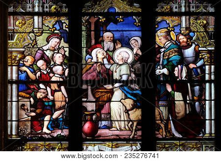 PARIS, FRANCE - JANUARY 04: Saint Genevieve giving sight to his mother in the presence of Saint Marcel, stained glass window in Saint Severin church in Paris, France on January 04, 2018.
