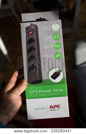 Paris, France - Mar 31, 2018: Man Holding Against Messy Table Background A Apc Ups Power Strip With 
