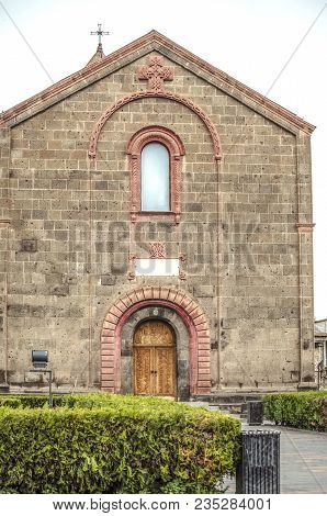 Facade With Decorative Patterned Arches And Openwork Cross Under The Roof Of The Church Of St. Mesro
