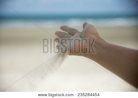 Freedom Hand,release And Wellness Concept.hand Of Woman Release Sand On Seabeach And Water Backgroun