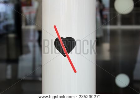 End Of Love. Crossed Heart. Sticker On The White Column. No Love