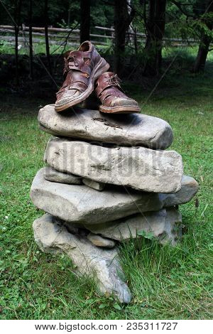 Old Mascul Shoes On A Pedestal From The Stones