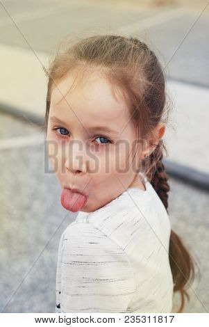 Portret Llittle Blod Girl Showing The Tongue Naughty Face Expression.