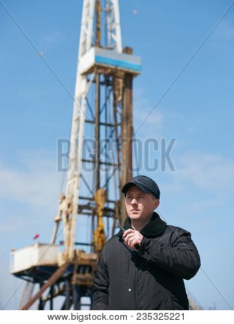 Security Guard Using Portable Wireless Transceiver. Security Man With Walkie Talkie, Standing Outdor