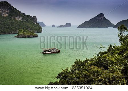 In The Gulf Of Thailand, The Islets Of The Chumphon Archipelago Are Seen, Among Which A Passenger Sh