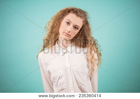 Close Up Portrait Of Beautiful Woman With Curly Fair Hair Isolatrd On The Blue Bcakground. Hairdress