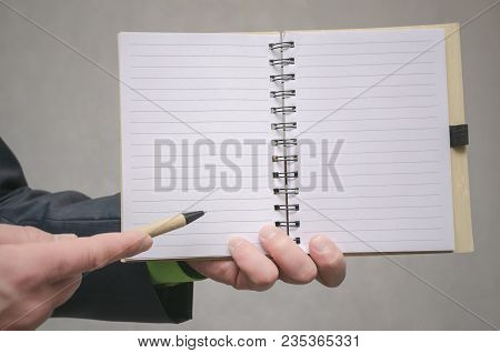 Businessman Holds In Hand A Note Pad With Pen. To Do List Template. Goals Or Business Tricks. Busine
