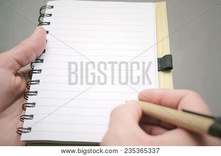 Businessman Holds In Hand A Note Pad With Pen. To Do List Template. Goals Or Business Tricks. Busine