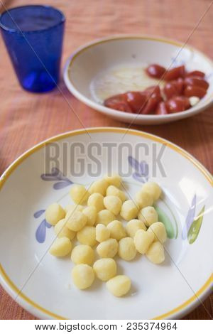 Dish Of Potato Small Dumplings With Pieces Of Fresh Tomatoes