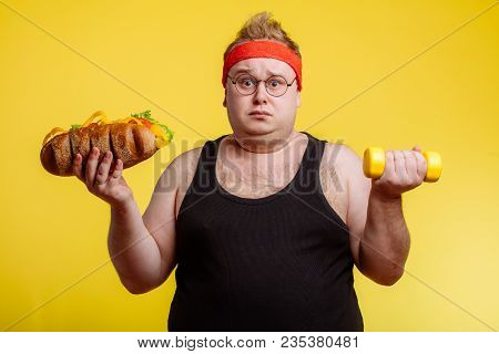 Fat Sportsman Has Ruined The Diet With Yummy Humburger. Gluttony.