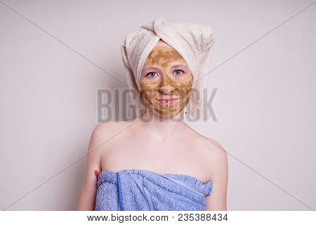 Young Woman With Healing Earth Or Clay Beauty Facial Mask, A Natural Ayurveda Treatment For Acne Or 