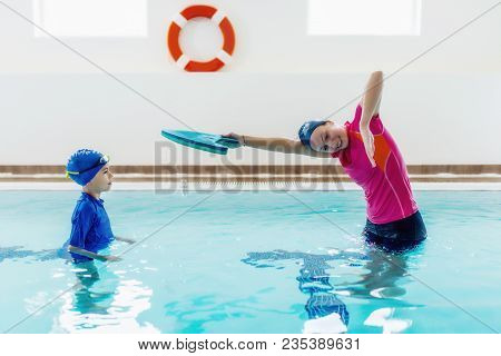 Boy Having A Swimming Lesson With Instructor