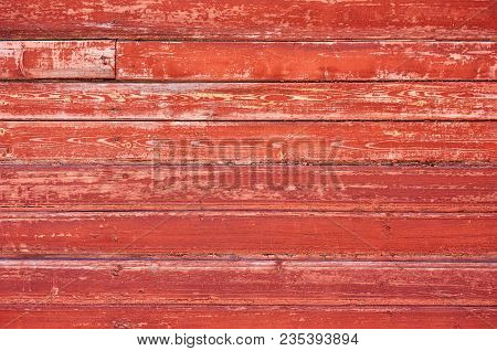 Old Wooden Background Painted With Red Paint With A Texture Of Cracks And Scratches. Red Background