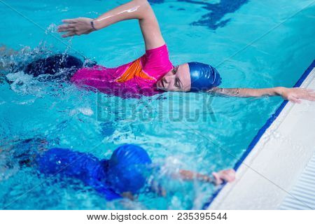Swimming Lesson. Cute Little Boy Learning To Swim With Swimming Instructor