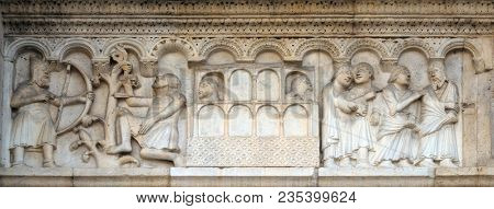 MODENA, ITALY - JUNE 04: Plate with stories from Genesis: Killing of Cain and the Ark of Noah, relief by Wiligelmo, Modena Cathedral, Italy on June 04, 2017.
