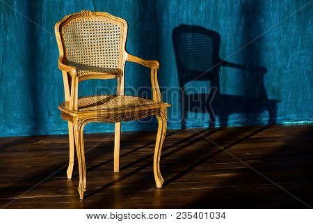 Old Chair On A Blue Wall Background