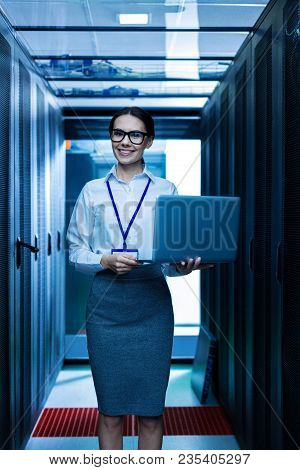 Wonderful Day. Content Young Professional Woman Smiling And Holding Her Laptop