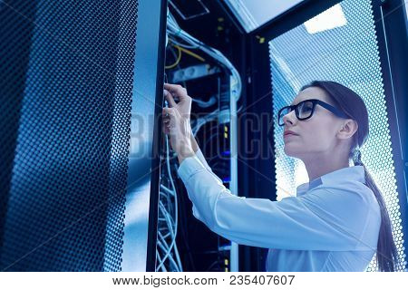 Fixing Wires. Determined Smart Woman Working In A Service Cabinet And Repairing Wires