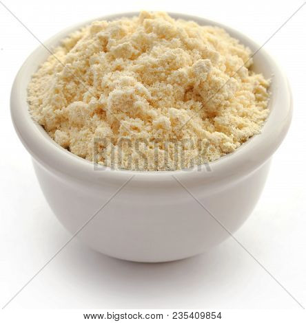 Gram Flour In A Bowl Over White Background
