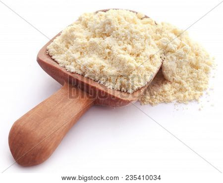 Gram Flour In Wooden Scoop Over White Background