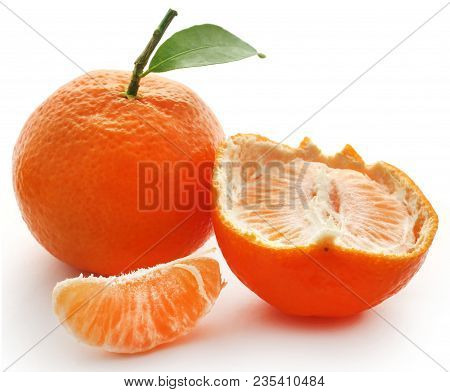 Fresh Orange With Green Leaves Over White Background