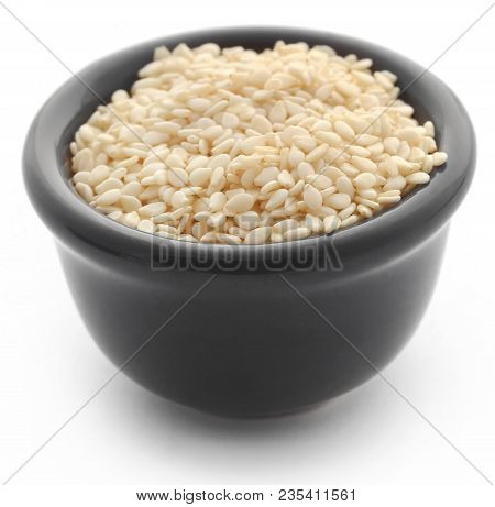 Peeled Sesame Seeds In A Black Bowl Over White Background