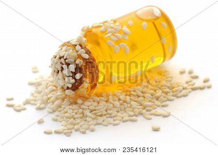 Peeled Sesame Seeds With Oil In A Jar Over White
