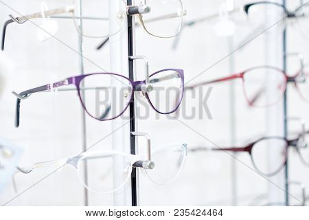 Sideview Of Fashionable Optical Eyeglasses, Hanging On Transparent Set With Other Glasses. Vision Im