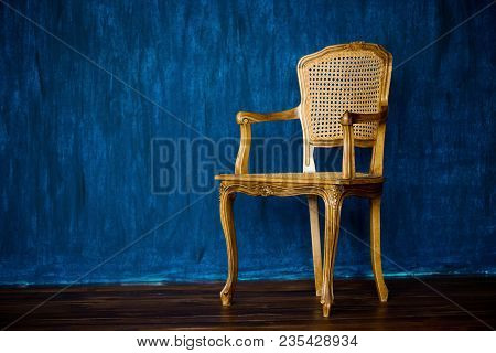 Old Chair On A Blue Wall Background