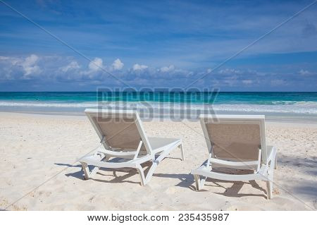 Two White Beach Chairs On The Empty Beach In Play Del Carmen, Yucatan, Mexico