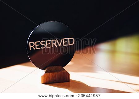 Photo Of Restaurant Table Reseved By Client. Reservation Sign On Table Against Blurred Background. N