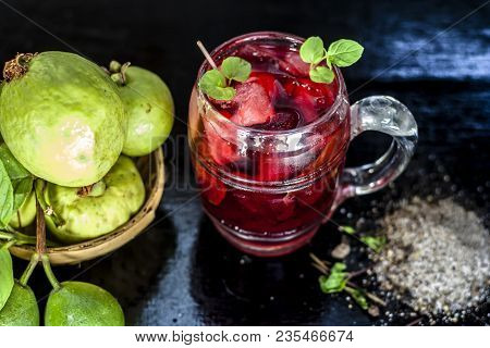 Close Up Of Popular Indian Shrabat Of Guava With Sugar And Masala In A Glass With Raw Fresh Guava On