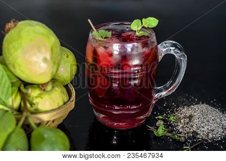 Close Up Of Popular Indian Shrabat Of Guava With Sugar And Masala In A Glass With Raw Fresh Guava On
