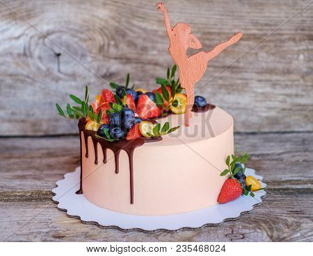Beautiful Homemade Cake With Cream Cheese Frosting , Strawberries And Blueberries On A Wooden Table