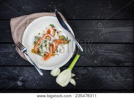 Lightly Salted Salmon With Fennel And Apple, Served With Cutlery And Linen Napkin On The White Plate