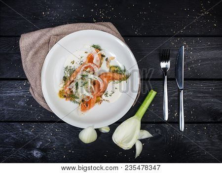 Lightly Salted Salmon With Fennel And Apple, Served With Cutlery And Linen Napkin On The White Plate