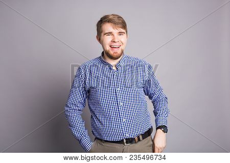 Portrait Of A Handsome Young Man Smiling Against Blue Background