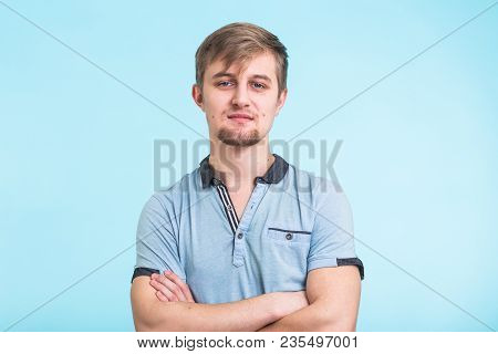 Portrait Of A Handsome Young Man Smiling Against Blue Background