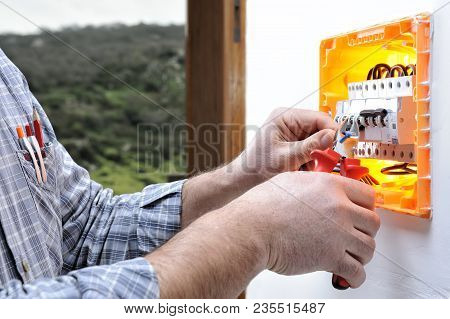 Electrical Technician To Work On A Residential Electrical Panel, Cuts The Wire With A Cable Cutter