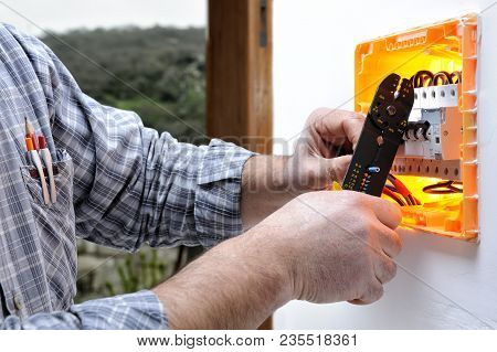 Electrical Technician To Work On A Residential Electrical Panel, Prepares The Wire With A Wire Strip