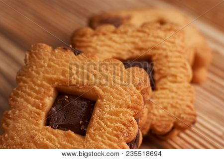 Stacked Chocolate Chip Cookies On A Light Wooden Background