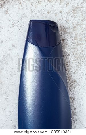 Blue Shampoo On Foam Background Top View