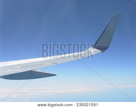 View Of Airplane Wing While In Flight.